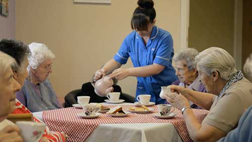 Carer serves our care home residents some tea