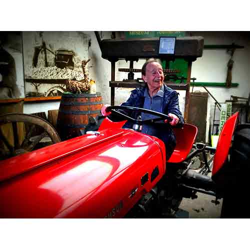 resident from residential care home enjoys tractor museum